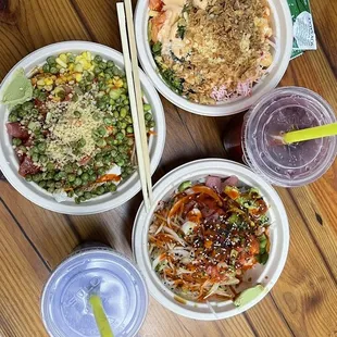 three bowls of food on a wooden table