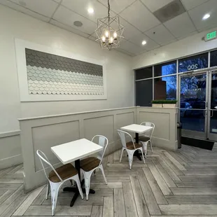 a dining area with tables and chairs