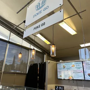 the inside of a bakery with a sign above the counter