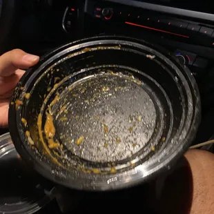 a person holding a dirty bowl