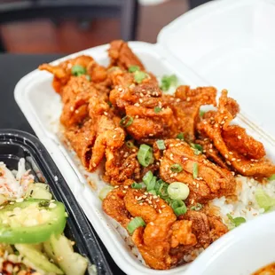 a plate of chicken and rice with a drink