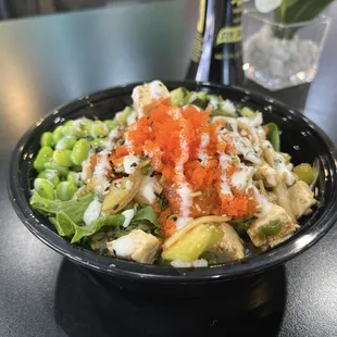 Regular Poke Bowl with a rice and mixed greens base salmon + tofu. And a million toppings!
