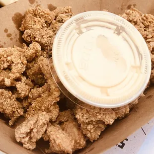 a container of fried chicken with a plastic lid