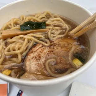 a bowl of ramen with chopsticks