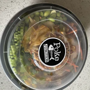 Half brown rice and salad with spicy tuna, salmon and chicken with a variety of toppings.  Yum!!