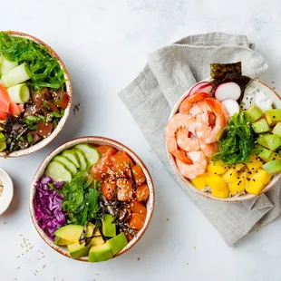 three bowls of food on a table