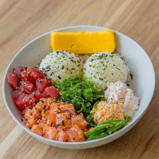 a bowl of sushi and vegetables