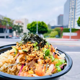 a person holding a bowl of food