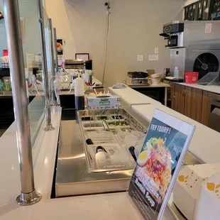 a restaurant counter with a menu on the counter