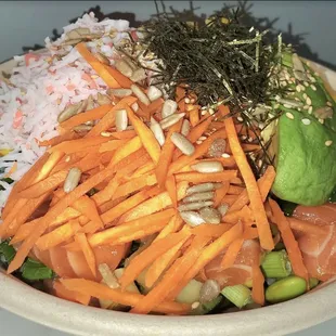 a bowl of sushi and vegetables