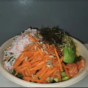 a bowl of sushi and vegetables