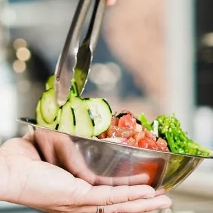 a person holding a bowl of food