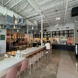 the interior of a restaurant with tables and chairs