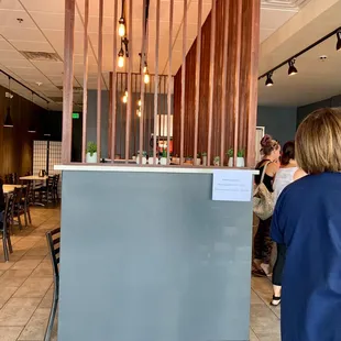 people sitting at tables in a restaurant