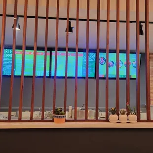 a bar with a large screen in the background