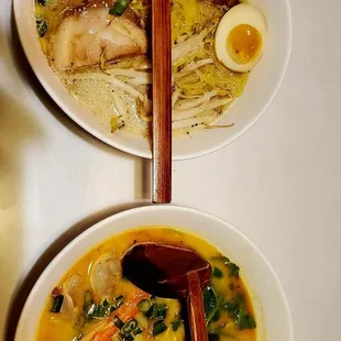two bowls of soup with chopsticks