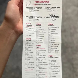 a person holding a ticket for poke bowl