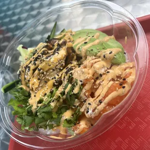 Poke bowl: spicy salmon, eel, cilantro, cucumber and avocado topped with spicy mayo and sesame seed.