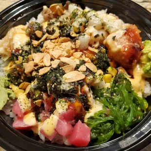 a bowl of sushi and vegetables