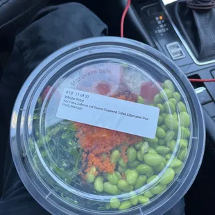 a plastic container filled with green beans and carrots