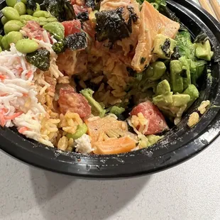 Poke bowl with spicy tuna and seared salmon, house poke sauce and spicy tuna sauce.