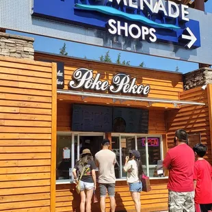 people standing outside of a store