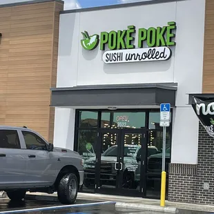 a pickup truck parked in front of the store