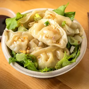 Steamed Chicken Gyoza  Tender, juicy chicken wrapped in a soft, delicate dough, steamed to perfection. A delightful, flavorful bite .