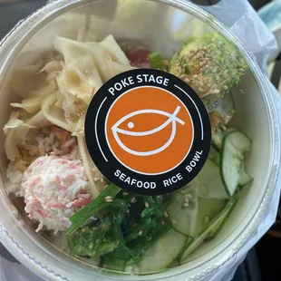 Poké bowl with ginger, crab, ahi, avocado, seaweed, pickled cucumber, furikake