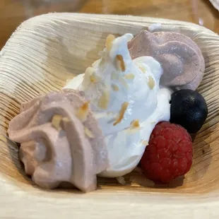 a bowl of ice cream and berries
