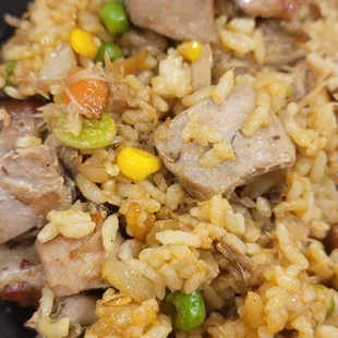 a plate of rice with meat and vegetables