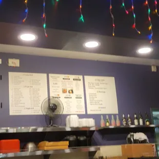 a view of a restaurant with lights strung from the ceiling