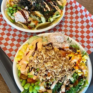 two bowls of food on a tray