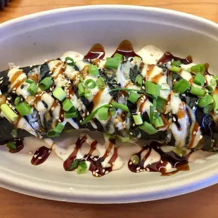 Deconstructed Musubi with furikake rice, spam, and egg, topped with eel sauce, aioli and green onions