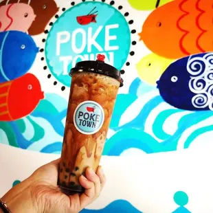 a hand holding a cup of bubble tea