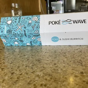 a box of poke and sushi burritos