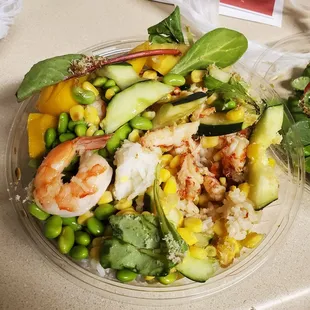 Shrimp and crawfish bowl with edamame, corn, cucumber, spring mix and Mango on top of sushi rice