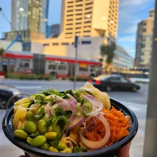 a person holding a bowl of food