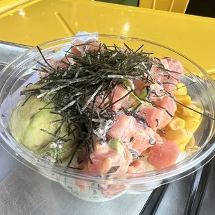 Small poke bowl with tuna, avocado, corn, seaweed, and crab salad