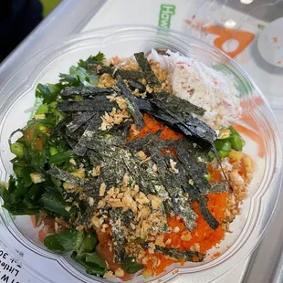 a plate of sushi with rice and vegetables