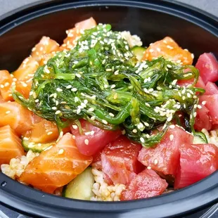 Large poke bowl: 2 scoops of salmon, 1 of tuna, brown rice base, cucumbers, avocado, seaweed salad, sesame seeds, and poke sauce.