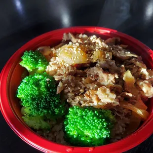 a bowl of rice and broccoli