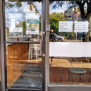 a broken glass door of a restaurant