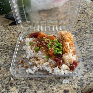 a plastic container filled with rice and vegetables