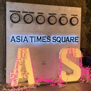 the asia times square sign and clocks