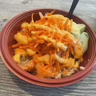 Poke Bowl (Small - Two Scoops) with brown rice, salmon, and shrimp. Topped with carrots and cucumber with spicy Mayo