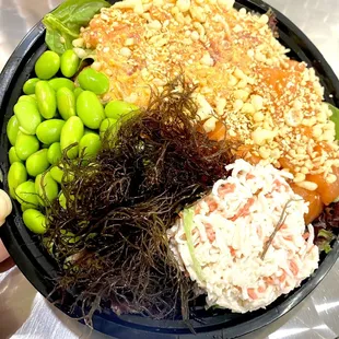 Spicy ahi and salmon bowl with Spring mix salad on sushi rice.