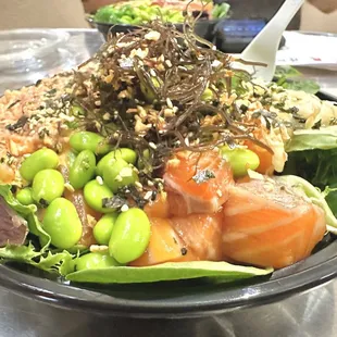 Spicy Ahi and Shoyu Salmon on brown rice and Spring Mix.  Toppings include ogo, edamame, ginger and Ocean Salad.