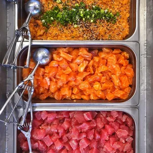 three trays of different types of food