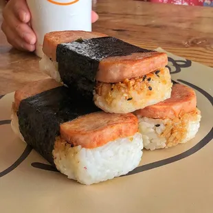 three pieces of sushi on a plate